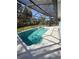 Inviting screened-in pool with a sun-drenched pool deck and lush surroundings at 1982 Seton Dr, Clearwater, FL 33763