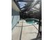 A covered in-ground pool with surrounding patio and screen enclosure at 1982 Seton Dr, Clearwater, FL 33763