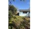 Side yard showing the home's exterior, surrounding greenery, and ample space at 1982 Seton Dr, Clearwater, FL 33763