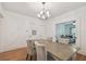 Bright dining room with hardwood floors, modern chandelier, and connection to the living room at 2807 W Estrella St # 102, Tampa, FL 33629