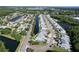 Aerial view showcases a serene residential neighborhood featuring canal-front homes, lush greenery, and scenic roadways at 284 Hemingway Dr, Oldsmar, FL 34677