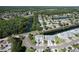 Scenic aerial view of a well-manicured neighborhood with lush landscaping, serene ponds and tree-lined streets at 284 Hemingway Dr, Oldsmar, FL 34677