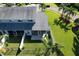 Aerial view of a townhome with screened patios and a well-maintained lawn surrounded by a white fence at 284 Hemingway Dr, Oldsmar, FL 34677
