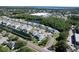 Expansive aerial view of townhome community along a lake, showcasing well-maintained landscaping and convenient street access at 284 Hemingway Dr, Oldsmar, FL 34677
