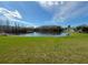Beautiful backyard overlooking a tranquil pond with lush green grass at 284 Hemingway Dr, Oldsmar, FL 34677