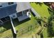 Aerial view of a fenced backyard with screened-in patio, lush lawn, and privacy fence at 284 Hemingway Dr, Oldsmar, FL 34677