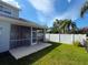 Screened-in lanai with a fenced yard, lush lawn and palm tree views at 284 Hemingway Dr, Oldsmar, FL 34677