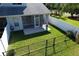 Aerial view of a fenced backyard with screened-in patio, lush lawn, and privacy fence at 284 Hemingway Dr, Oldsmar, FL 34677