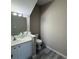 Bright bathroom featuring a single sink vanity, toilet, and updated flooring at 284 Hemingway Dr, Oldsmar, FL 34677