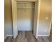 Bedroom featuring a closet with bi-fold doors and laminate wood flooring at 284 Hemingway Dr, Oldsmar, FL 34677