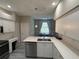 Bright kitchen featuring modern appliances, an island with a sink, and stylish countertops at 284 Hemingway Dr, Oldsmar, FL 34677