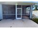 Enclosed screened patio with ceiling fan offers a relaxing outdoor space and is accessible through sliding glass doors at 284 Hemingway Dr, Oldsmar, FL 34677