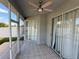 Cozy screened patio with tiled floor, ceiling fan, and sliding glass doors at 284 Hemingway Dr, Oldsmar, FL 34677