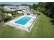Aerial view of a community pool area featuring lounge chairs, umbrellas, and a nearby cabana at 284 Hemingway Dr, Oldsmar, FL 34677