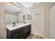 Bathroom features a double vanity with modern fixtures, and a decorative shower curtain at 3131 Royal Tuscan Ln, Valrico, FL 33594