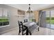 Dining room featuring tile floors, modern lighting, and a sliding glass door to the outside at 3131 Royal Tuscan Ln, Valrico, FL 33594