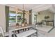 Bright dining room showcasing an industrial light fixture, a view, and indoor/outdoor kitchen at 33960 Anchor Light Ln, Wesley Chapel, FL 33543