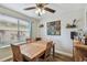 Dining room with wood-look tile flooring, large windows, and decorative wall art at 3406 Cypress Head Ct, Tampa, FL 33618