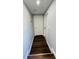 Hallway with dark laminate floors, gray walls, and white doors at 3426 28Th N St, St Petersburg, FL 33713