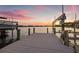 Detailed shot of dock with boat lift, showcasing the waterfront lifestyle and sunset views at 3626 10Th Ne St, St Petersburg, FL 33704