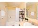 Cozy bathroom with a shower and tub combination and storage shelves for convenience at 4405 Tuscan Loon Dr, Tampa, FL 33619
