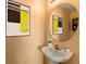 Stylish half bathroom with a modern sink, decorative mirror, and contemporary artwork at 4405 Tuscan Loon Dr, Tampa, FL 33619