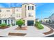 Charming three-story townhome with a private garage and landscaped front yard at 4405 Tuscan Loon Dr, Tampa, FL 33619