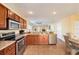 Well-equipped kitchen with stainless steel appliances, wooden cabinets, and a breakfast bar at 4405 Tuscan Loon Dr, Tampa, FL 33619