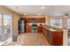 Beautiful kitchen with stainless steel appliances, wooden cabinetry, and an adjacent dining area at 4405 Tuscan Loon Dr, Tampa, FL 33619