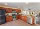 Modern kitchen featuring stainless steel appliances, wooden cabinetry, and tile flooring at 4405 Tuscan Loon Dr, Tampa, FL 33619