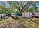 A spacious backyard with mature trees, a shed, and a boat provide ample storage and recreational opportunities at 4716 Gazania St, New Port Richey, FL 34652