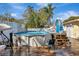 Above-ground backyard pool with wooden deck, ladder, patio furniture, and pool equipment at 4716 Gazania St, New Port Richey, FL 34652