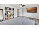 Bright bedroom featuring light gray walls, ceiling fan, and closet with lots of items at 4716 Gazania St, New Port Richey, FL 34652