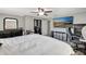 Spacious bedroom with a ceiling fan, TV, closet and dresser for ample storage at 4716 Gazania St, New Port Richey, FL 34652