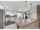 Modern kitchen featuring stainless steel appliances, brick backsplash, and a breakfast bar with pendant lighting at 4716 Gazania St, New Port Richey, FL 34652