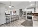 Open kitchen with stainless steel appliances, breakfast bar, and seamless flow into the living area at 4716 Gazania St, New Port Richey, FL 34652