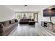 Bright living room with hardwood floors, contemporary sofas, and large windows at 4716 Gazania St, New Port Richey, FL 34652