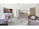 Inviting living room with hardwood floors, comfortable sofas, and seamless open-concept kitchen at 4716 Gazania St, New Port Richey, FL 34652