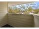 A tranquil balcony offers a serene outdoor space with a view of lush trees and nearby buildings at 5203 Bayshore Blvd # 5, Tampa, FL 33611
