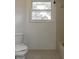 Simple bathroom with a white toilet and a window view at 5203 Bayshore Blvd # 5, Tampa, FL 33611