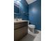 Half bathroom with blue walls, white sink, and chrome hardware at 5203 Bayshore Blvd # 5, Tampa, FL 33611