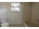 Bathroom with tiled walls, white toilet, and a bathtub next to a window at 5203 Bayshore Blvd # 5, Tampa, FL 33611