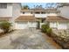 Townhouse exterior showcasing garages, a driveway, and lush landscaping at 5203 Bayshore Blvd # 5, Tampa, FL 33611