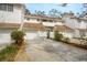 Charming townhome featuring white siding, a brown roof, attached garage and a well-maintained driveway at 5203 Bayshore Blvd # 5, Tampa, FL 33611