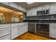 Well-lit kitchen with stainless steel appliances, black countertops, and distressed white cabinets at 5203 Bayshore Blvd # 5, Tampa, FL 33611