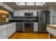 Well-lit kitchen with stainless steel appliances, black countertops, and distressed white cabinets at 5203 Bayshore Blvd # 5, Tampa, FL 33611