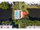 Aerial view of the pool surrounded by trees, water, and condos in a park-like setting at 5971 Terrace Park N Dr # 310, St Petersburg, FL 33709