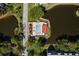 Aerial perspective of the pool area surrounded by lush greenery and ponds, providing a tranquil environment at 5971 Terrace Park N Dr # 310, St Petersburg, FL 33709