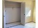 Bedroom closet with bi-fold doors, rod, and bare floors at 5971 Terrace Park N Dr # 310, St Petersburg, FL 33709