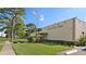 Exterior view of a community building with landscaped lawn and American flag at 5971 Terrace Park N Dr # 310, St Petersburg, FL 33709